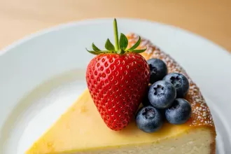 Create a high-resolution Pinterest pin image (1000x1500) of the prepared dish for the recipe " Classic New York Style Cheesecake ". Show a close-up of the final dish, beautifully styled, vibrant, and appetizing, with soft natural lighting and realistic textures. Do NOT include any text, title, logo, watermark, or background clutter. Keep the composition clean, minimalistic, and visually striking.